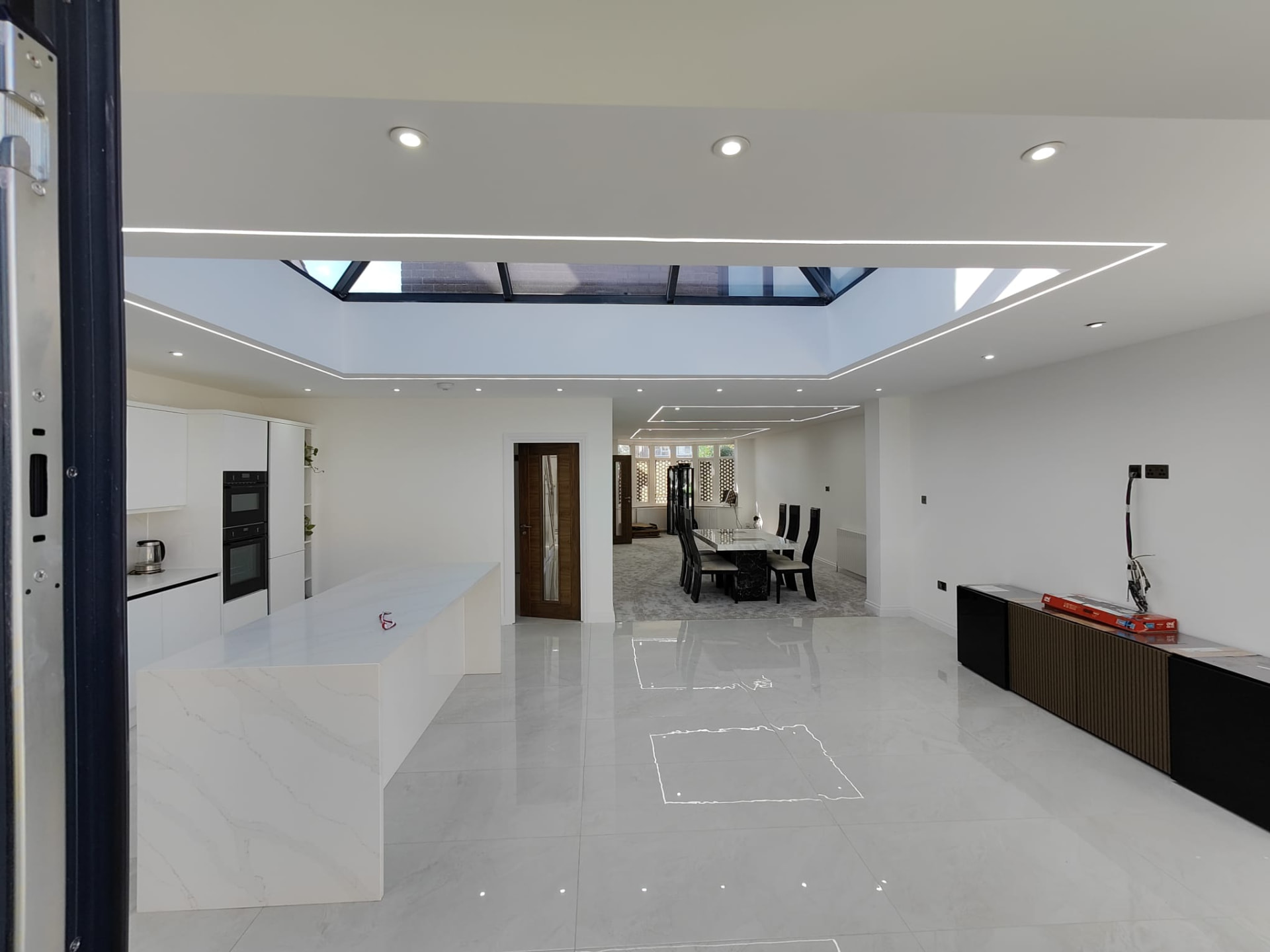 Wide view of finished kitchen extension with roof lantern and marble island, Leeds