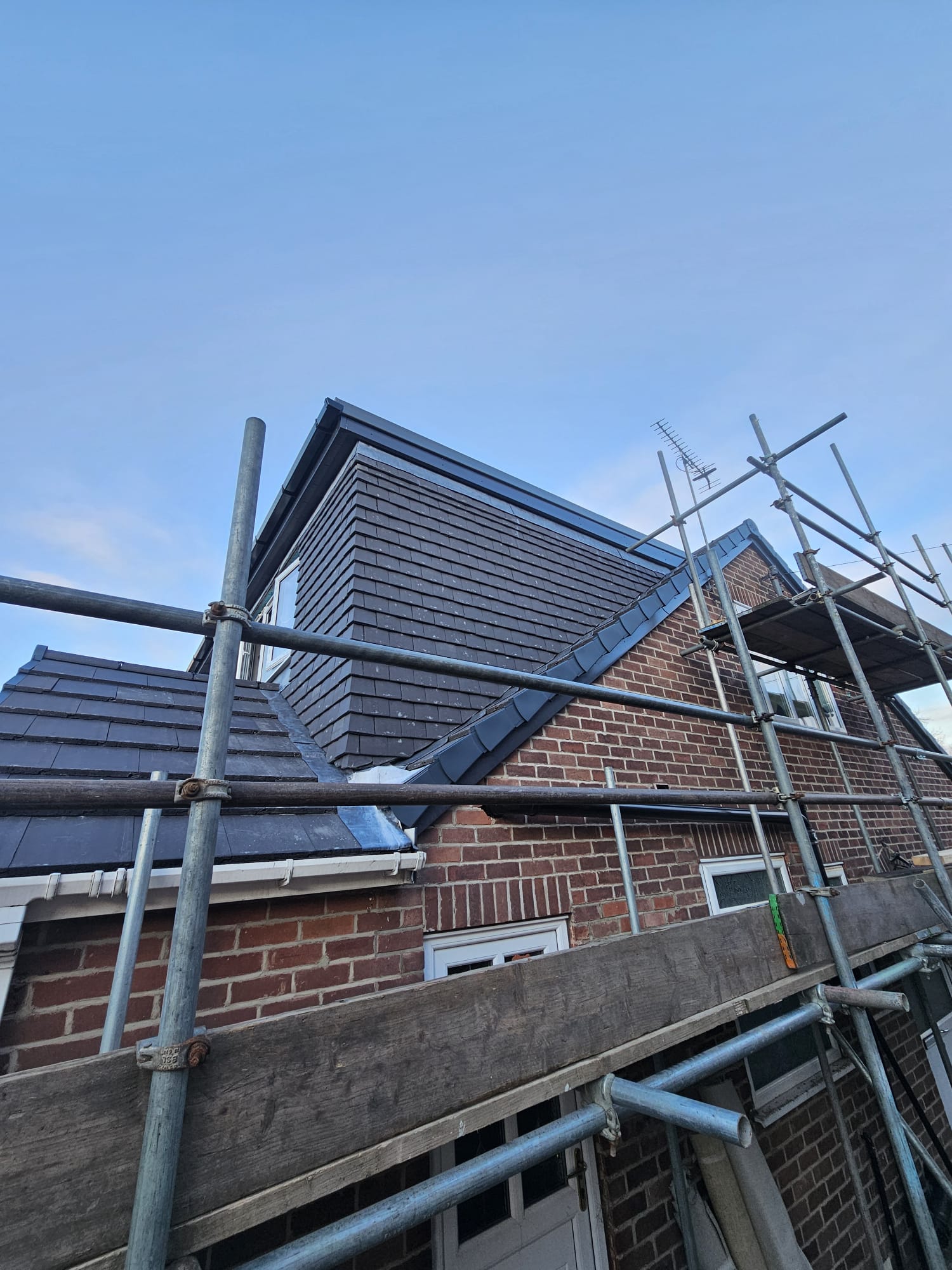 Leeds brick house extension under construction with scaffolding