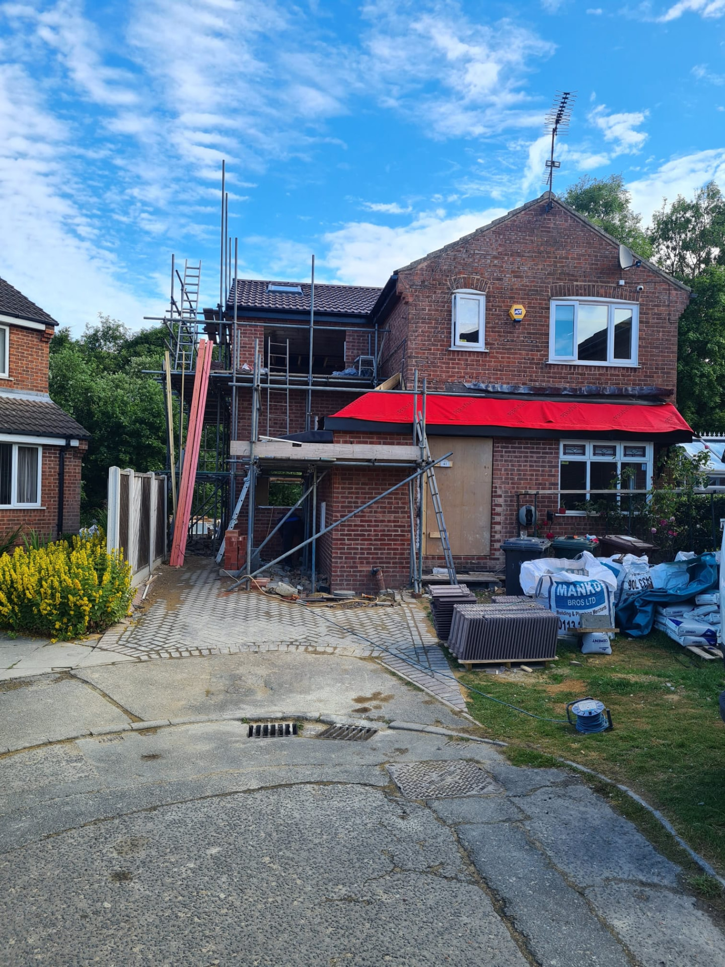 Dormer loft conversion mid-build with red weatherproofing membrane on the roof, Leeds